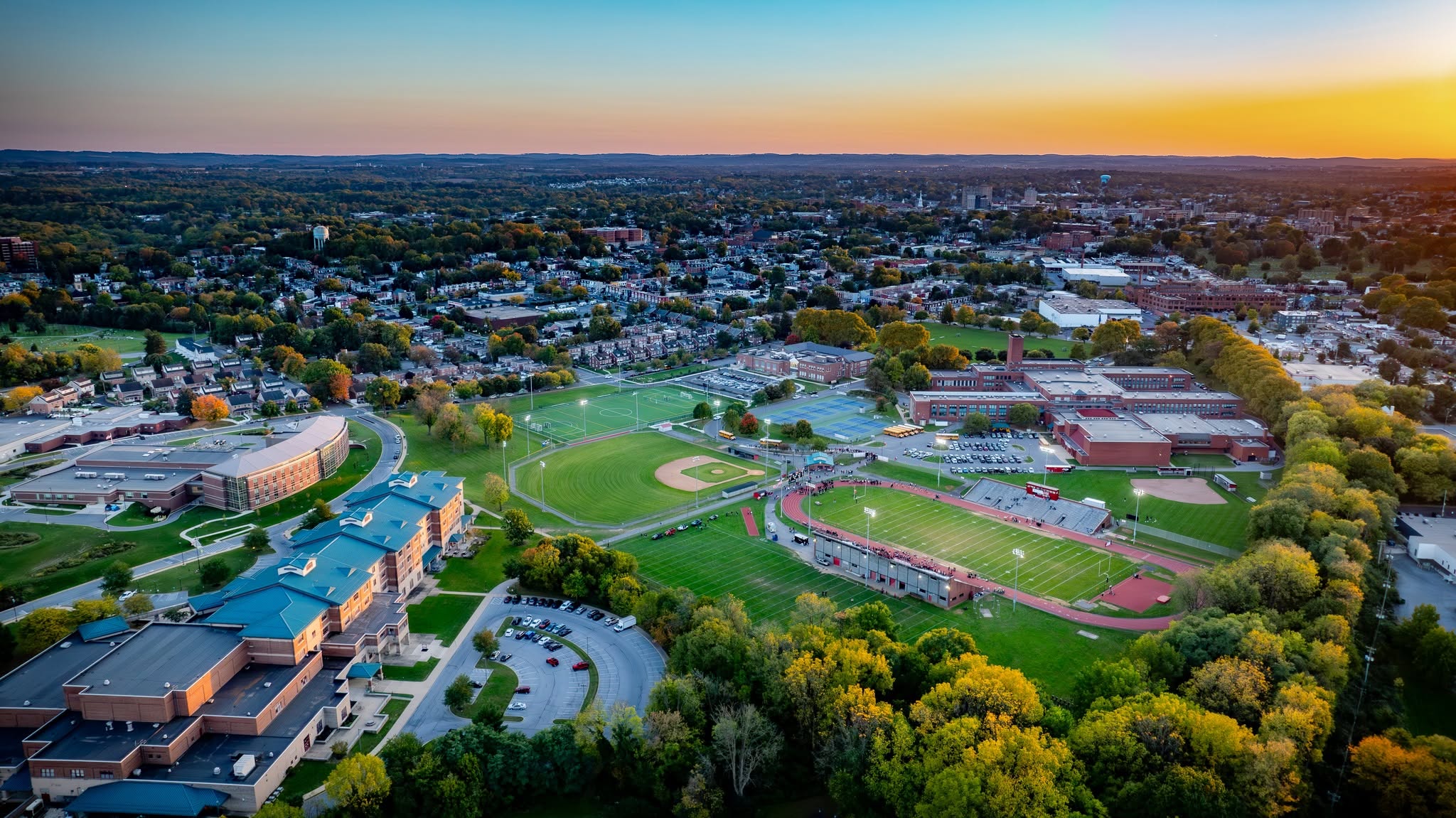 Aerial view of J.P. McCaskey High School campus and the surrounding Lancaster, Pennsylvania neighborhood at sunset